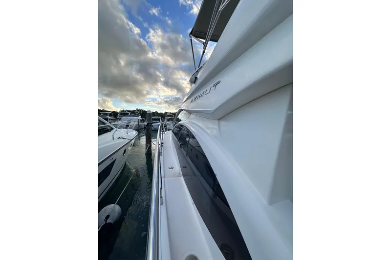 3 Princess Yacht Photos Pics 2011 Azimut 38 yacht docked, showcasing sleek design under a cloudy sky.