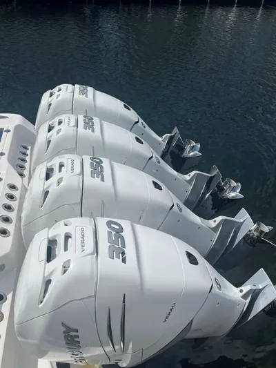  Yacht Photos Pics Four powerful outboard engines on a 2018 Blackwater 43 boat, docked on calm water.