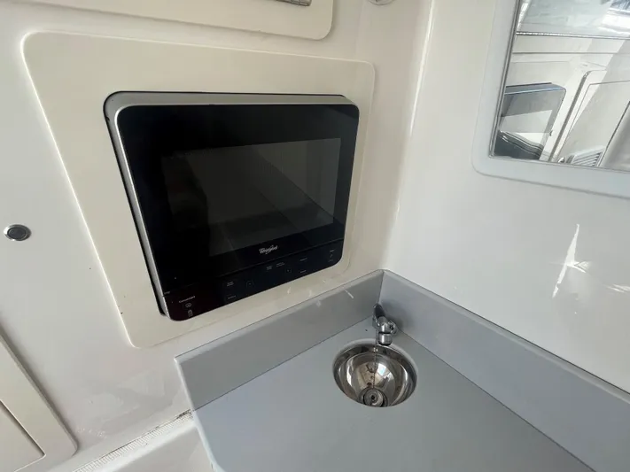  Yacht Photos Pics Compact kitchen area in a 2018 Blackwater 43 boat with microwave and sink.