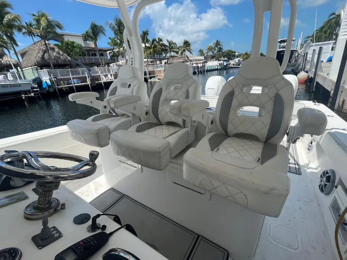  Yacht Photos Pics Luxury seating on a 2018 Blackwater 43 boat, docked by a scenic waterfront.