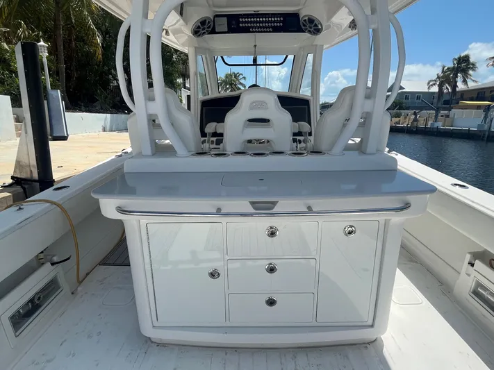  Yacht Photos Pics 2018 Blackwater 43 boat interior with white cabinetry and seating, docked by a canal.