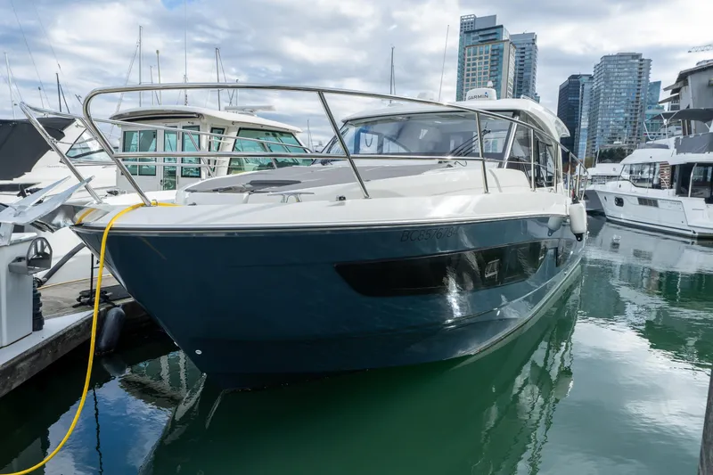 Misty Step Yacht Photos Pics 2023 Beneteau Antares 11 docked in marina, surrounded by modern buildings.