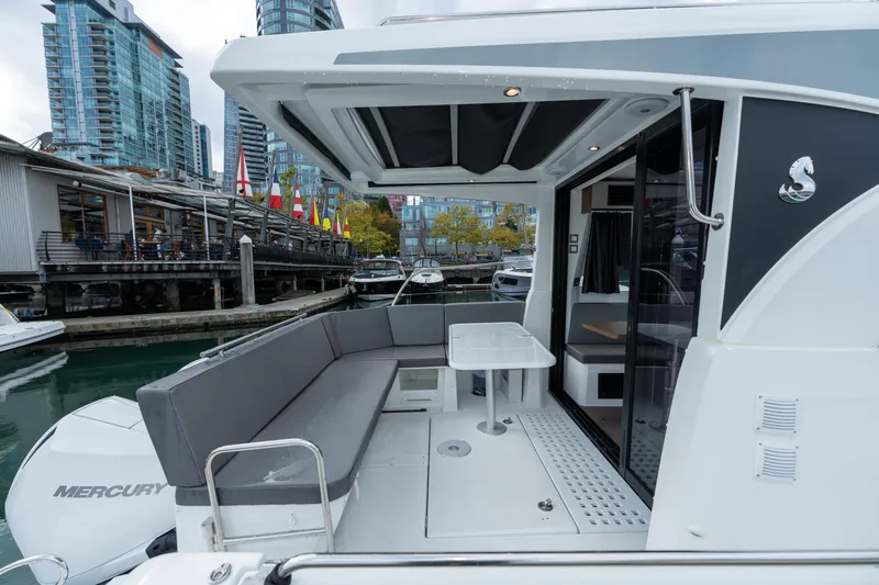 Misty Step Yacht Photos Pics 2023 Beneteau Antares 11 yacht with outdoor seating, docked in a marina.