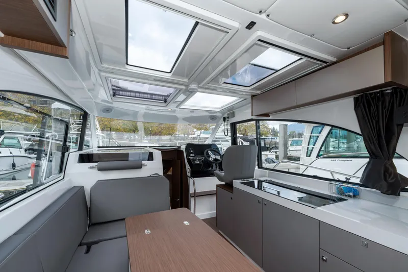 Misty Step Yacht Photos Pics Interior of 2023 Beneteau Antares 11 boat, featuring modern seating and panoramic windows.