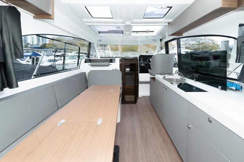 Misty Step Yacht Photos Pics Interior of 2023 Beneteau Antares 11, featuring modern design, spacious seating, and sleek kitchen area.