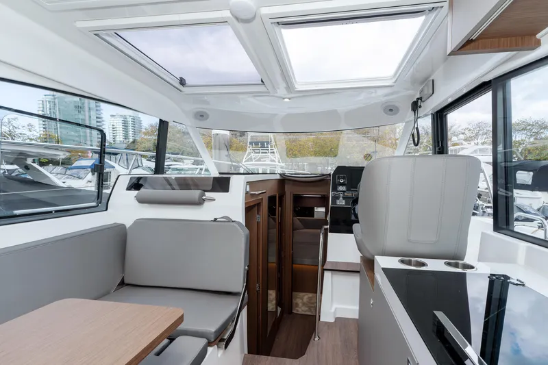 Misty Step Yacht Photos Pics Interior of 2023 Beneteau Antares 11 boat, featuring modern seating and navigation area.