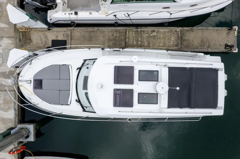 Misty Step Yacht Photos Pics 2023 Beneteau Antares 11 docked, aerial view showcasing sleek design and spacious deck layout.