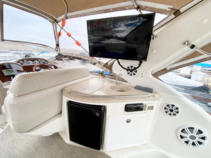 Tangled Up In Blue Yacht Photos Pics 2002 Regal 3860 Commodore yacht interior with TV, sink, and seating area.