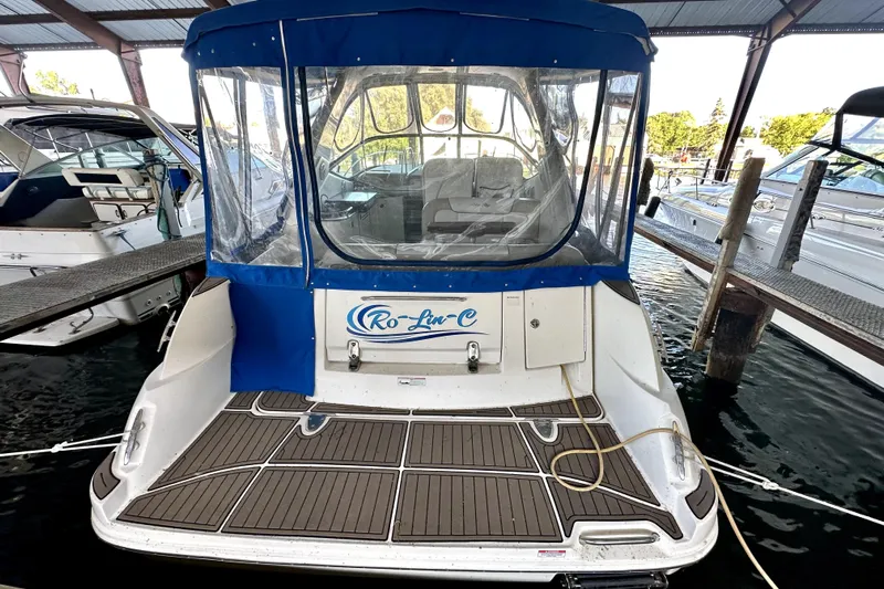  Yacht Photos Pics 2012 Sea Ray 330 Sundancer docked, featuring blue canopy and spacious deck area.