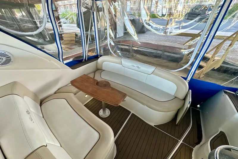  Yacht Photos Pics 2012 Sea Ray 330 Sundancer interior with cushioned seating and wooden table.