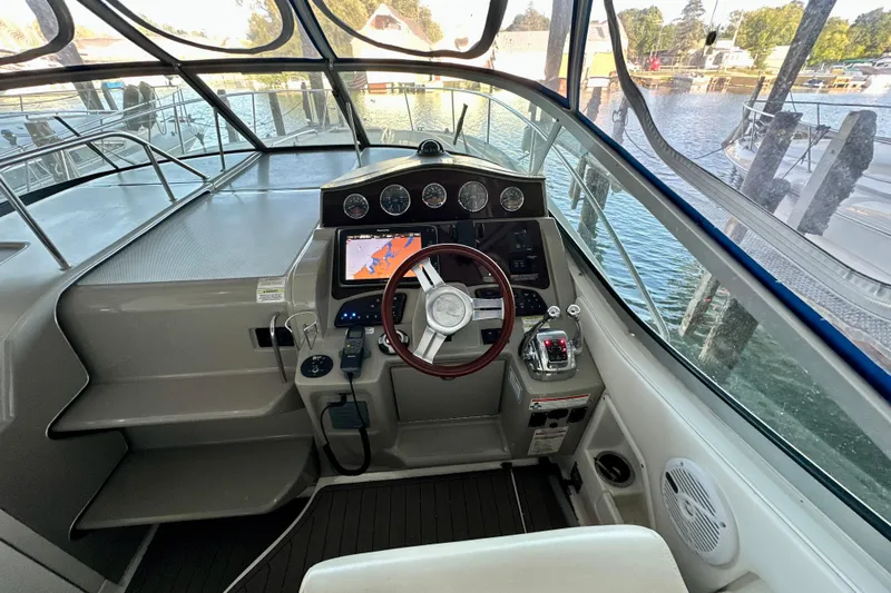  Yacht Photos Pics 2012 Sea Ray 330 Sundancer helm with navigation system and wooden steering wheel.