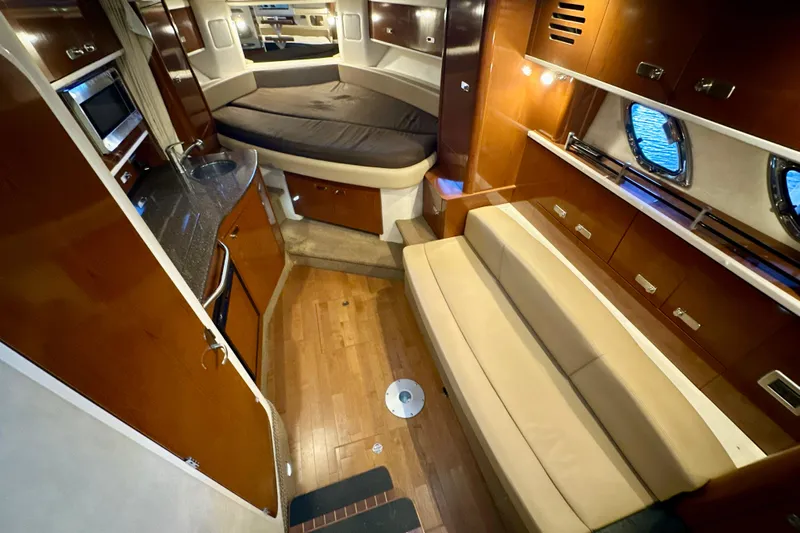  Yacht Photos Pics Luxurious interior of 2012 Sea Ray 330 Sundancer yacht with cozy seating and modern amenities.