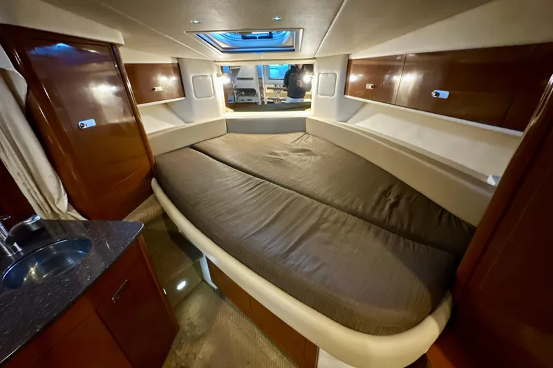  Yacht Photos Pics Interior cabin of 2012 Sea Ray 330 Sundancer with bed and wooden cabinetry.