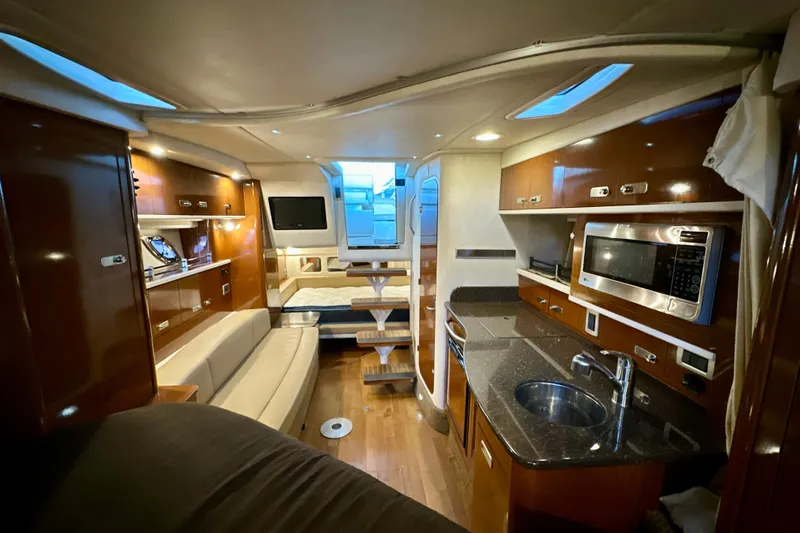  Yacht Photos Pics Luxurious interior of 2012 Sea Ray 330 Sundancer yacht with modern kitchen and seating area.