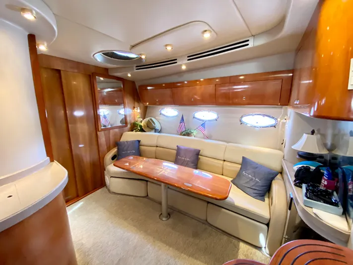 Tangled Up In Blue Yacht Photos Pics Luxurious interior of 2002 Regal 3860 Commodore yacht with plush seating and elegant wood finishes.