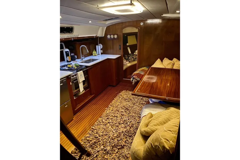 Aundrea Lynn Yacht Photos Pics Interior of 1997 Beneteau Oceanis 461 yacht with cozy kitchen and seating area.