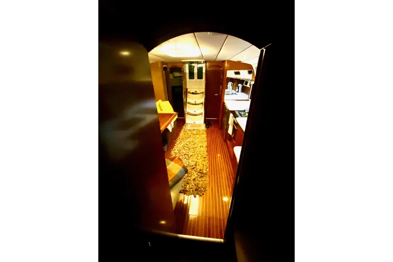 Aundrea Lynn Yacht Photos Pics Interior view of 1997 Beneteau Oceanis 461 yacht, featuring elegant wood finishes and cozy seating.