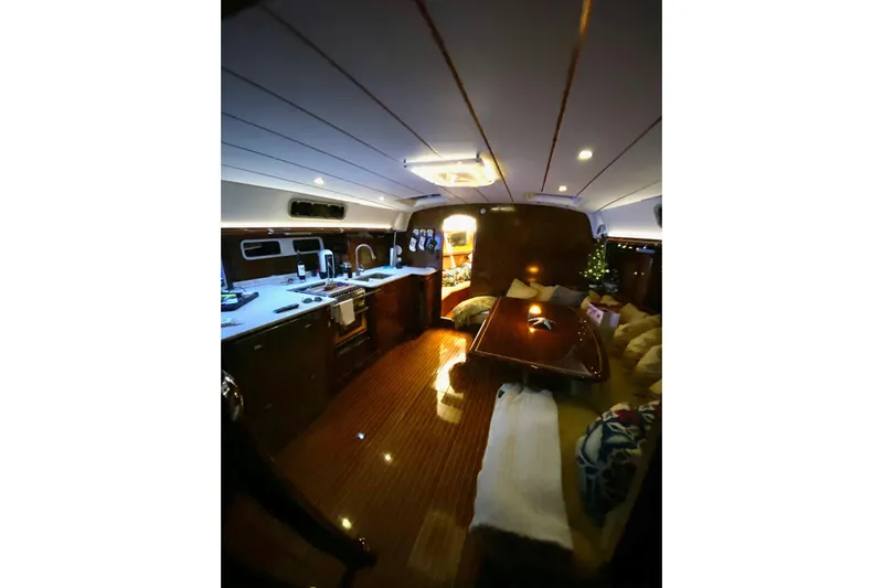 Aundrea Lynn Yacht Photos Pics Interior of 1997 Beneteau Oceanis 461 yacht, featuring cozy seating and modern kitchen amenities.
