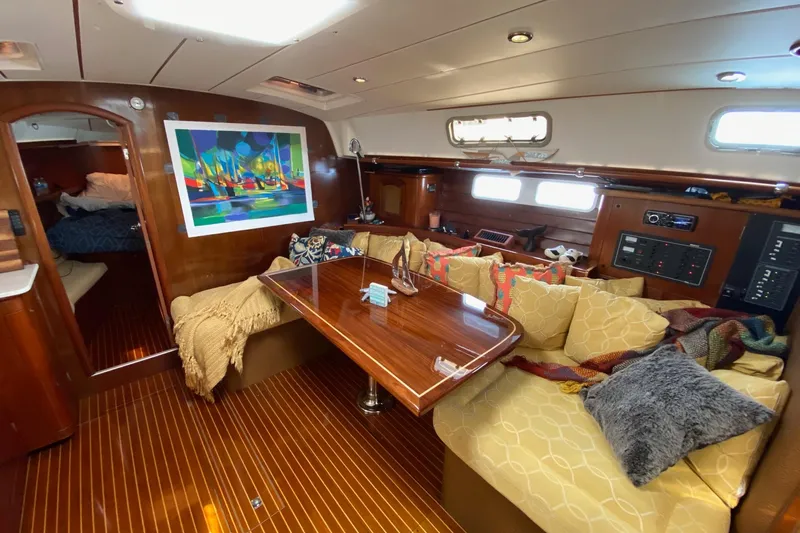 Aundrea Lynn Yacht Photos Pics Luxurious interior of 1997 Beneteau Oceanis 461 yacht with cozy seating and vibrant artwork.