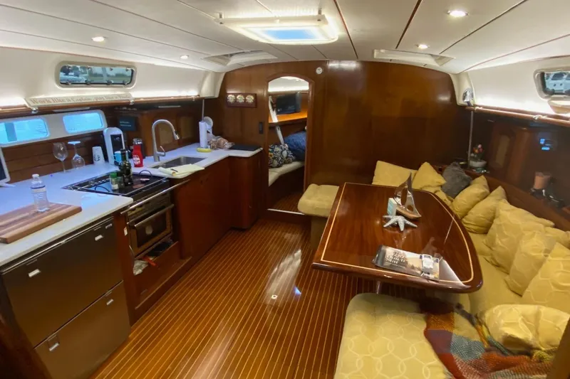 Aundrea Lynn Yacht Photos Pics Interior of 1997 Beneteau Oceanis 461 yacht with kitchen and cozy seating area.