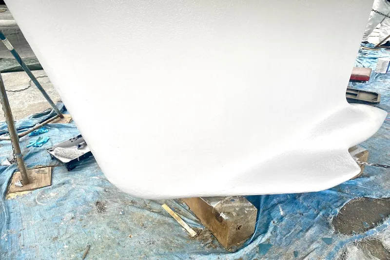 Aundrea Lynn Yacht Photos Pics Freshly painted keel of a 1997 Beneteau Oceanis 461 sailboat on a tarp.