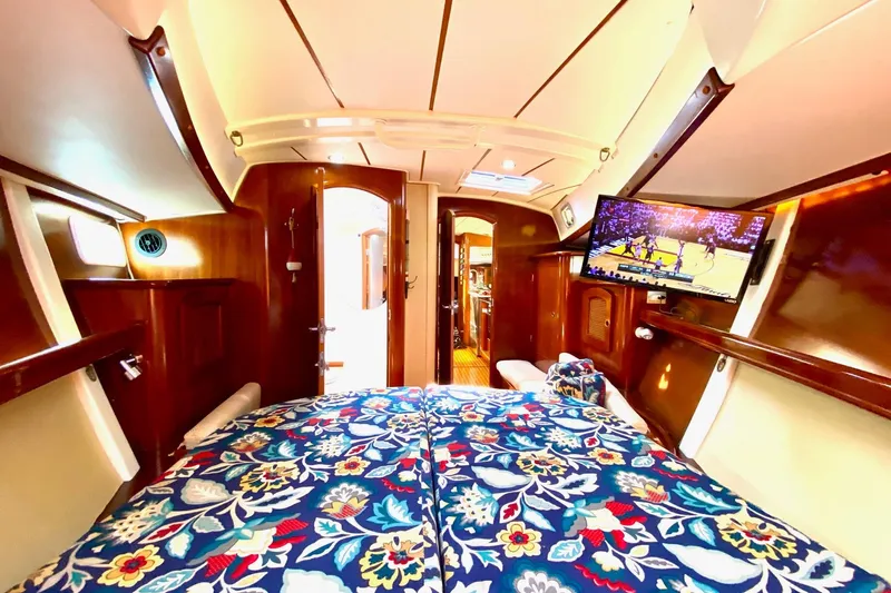 Aundrea Lynn Yacht Photos Pics Luxurious interior of 1997 Beneteau Oceanis 461 yacht with floral bedding and TV.