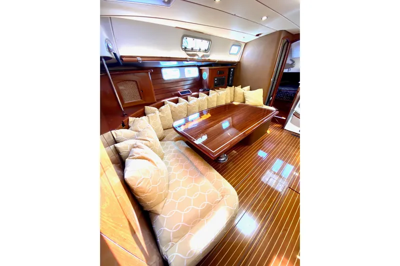 Aundrea Lynn Yacht Photos Pics Luxurious interior of 1997 Beneteau Oceanis 461 yacht with polished wood and plush seating.