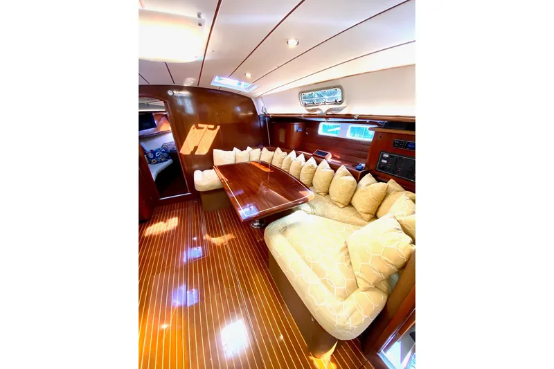 Aundrea Lynn Yacht Photos Pics Luxurious interior of 1997 Beneteau Oceanis 461 yacht with elegant wood finish and plush seating.
