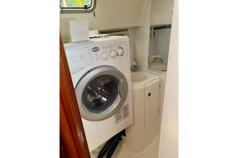 Aundrea Lynn Yacht Photos Pics Laundry area with washer in 1997 Beneteau Oceanis 461 yacht bathroom.