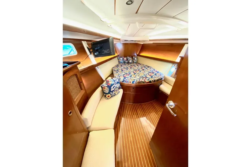 Aundrea Lynn Yacht Photos Pics Luxurious cabin interior of 1997 Beneteau Oceanis 461 sailboat with wood finish and cozy bedding.