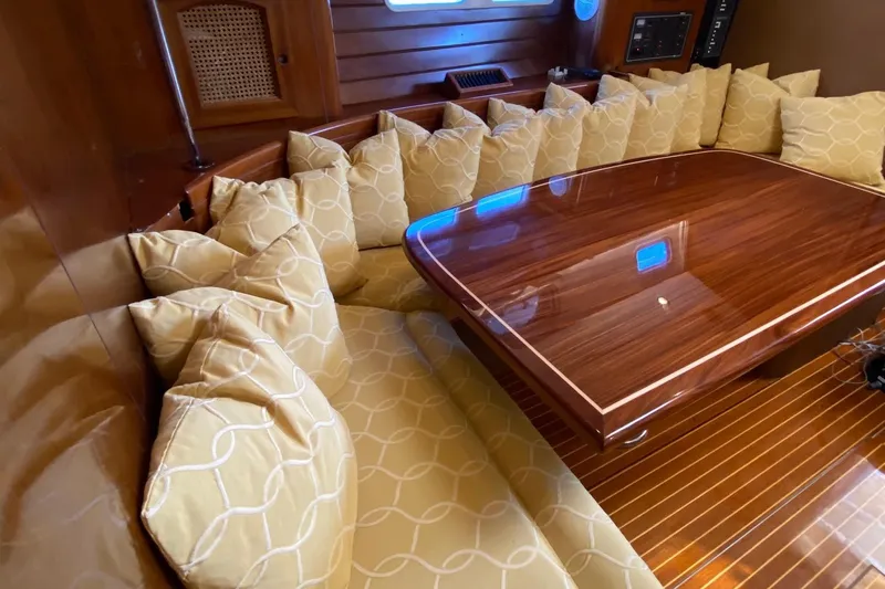 Aundrea Lynn Yacht Photos Pics Luxurious interior of 1997 Beneteau Oceanis 461 with polished wood table and cushioned seating.