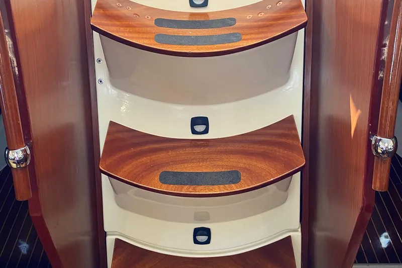 Aundrea Lynn Yacht Photos Pics Wooden steps inside a 1997 Beneteau Oceanis 461 yacht, featuring sleek design and grip strips.