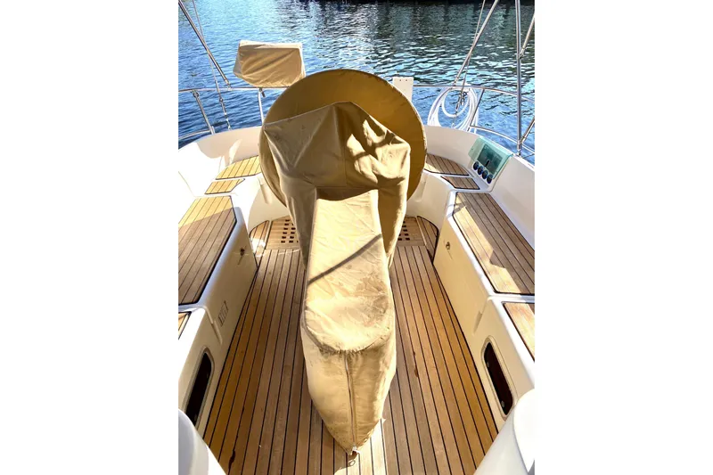 Aundrea Lynn Yacht Photos Pics 1997 Beneteau Oceanis 461 sailboat cockpit with covered helm, teak flooring, and seating.