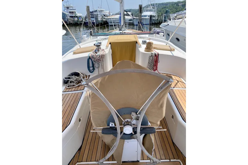 Aundrea Lynn Yacht Photos Pics 1997 Beneteau Oceanis 461 sailboat cockpit with covered steering wheel, docked at marina.