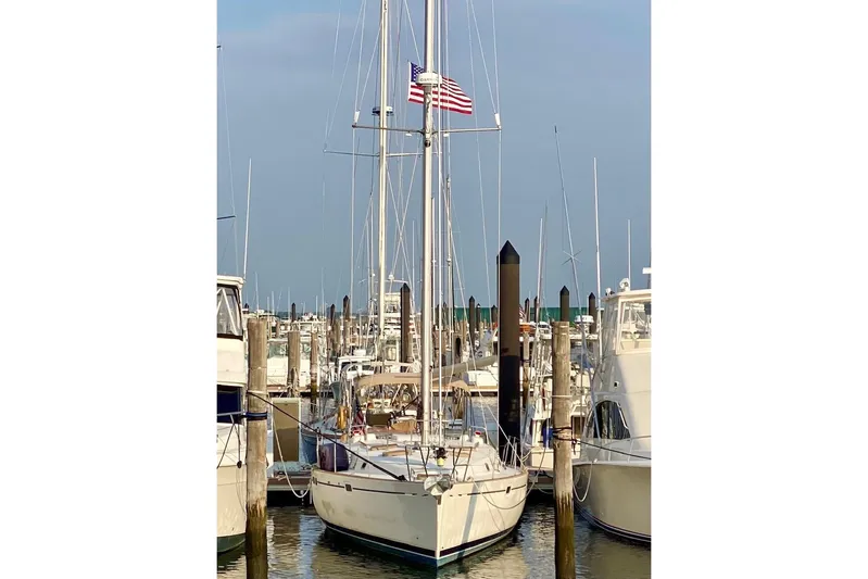 Aundrea Lynn Yacht Photos Pics 1997 Beneteau Oceanis 461 sailboat docked at marina with American flag.