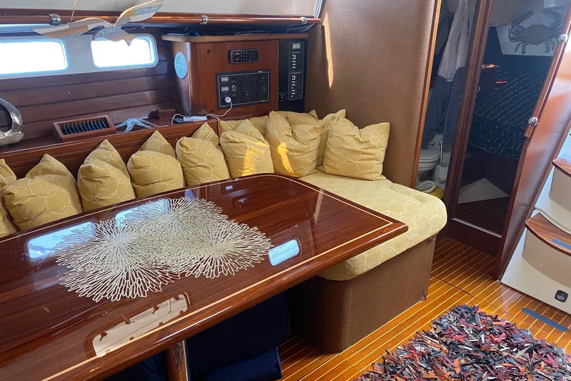 Aundrea Lynn Yacht Photos Pics Luxurious interior of 1997 Beneteau Oceanis 461 yacht with elegant seating and wooden table.