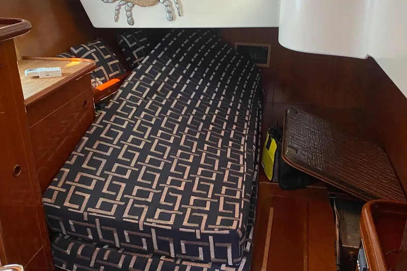 Aundrea Lynn Yacht Photos Pics Interior cabin of 1997 Beneteau Oceanis 461 with patterned cushions and wooden accents.