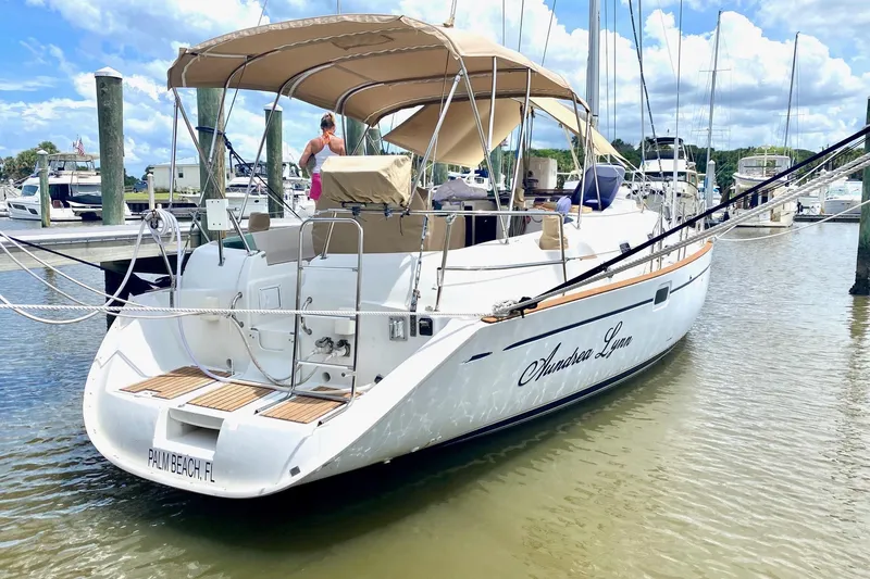 Aundrea Lynn Yacht Photos Pics 1997 Beneteau Oceanis 461 sailboat docked, featuring a beige canopy and sleek design.