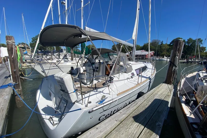 Celtic Knot Yacht Photos Pics 2014 Beneteau Oceanis 34 sailboat docked at marina under clear blue sky.
