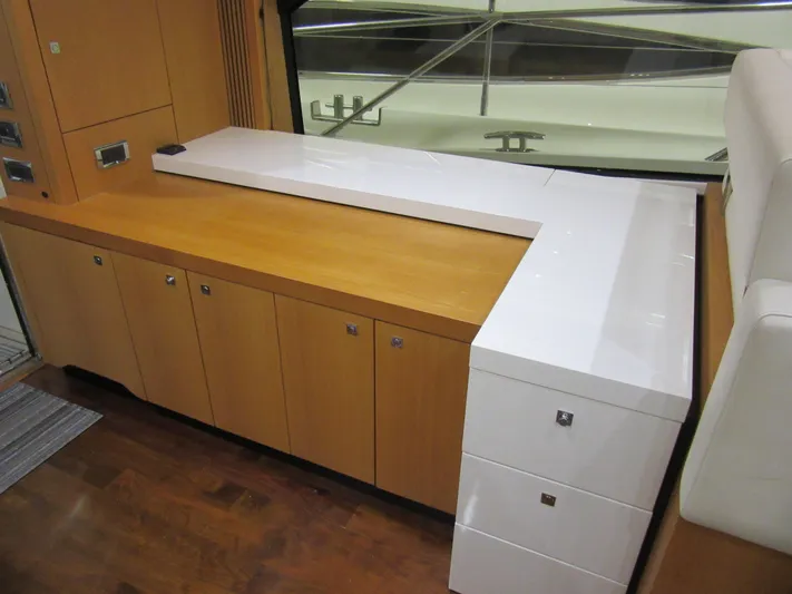 Skeis The Limit Yacht Photos Pics Interior of 2014 Sunseeker Manhattan 53 yacht with sleek wooden cabinetry and modern design.