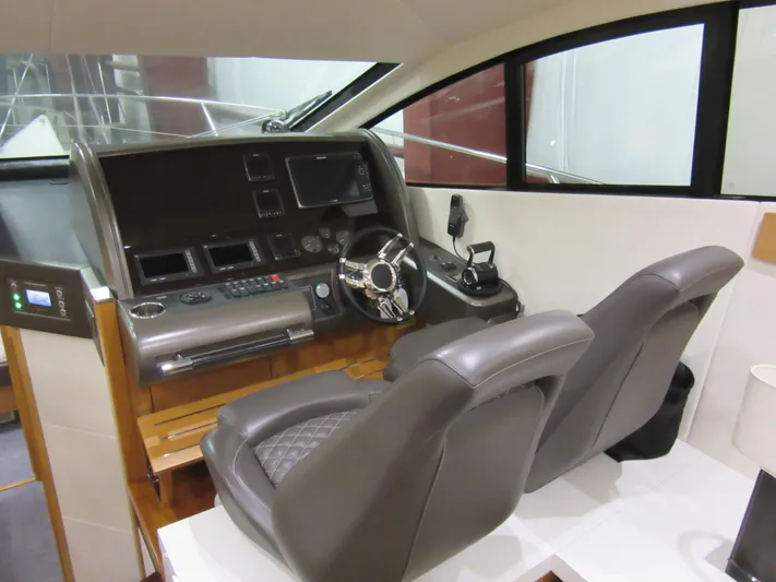 Skeis The Limit Yacht Photos Pics Interior helm of 2014 Sunseeker Manhattan 53 yacht with modern controls and seating.