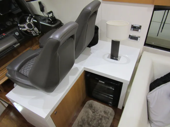 Skeis The Limit Yacht Photos Pics Interior of 2014 Sunseeker Manhattan 53 yacht with helm seats and modern decor.