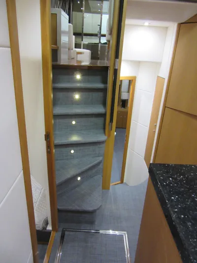 Skeis The Limit Yacht Photos Pics Interior staircase of 2014 Sunseeker Manhattan 53 yacht, featuring modern design and ambient lighting.