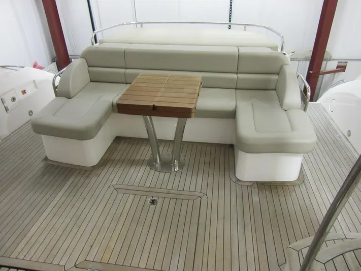 Skeis The Limit Yacht Photos Pics Luxurious seating area on 2014 Sunseeker Manhattan 53 yacht with wooden table.
