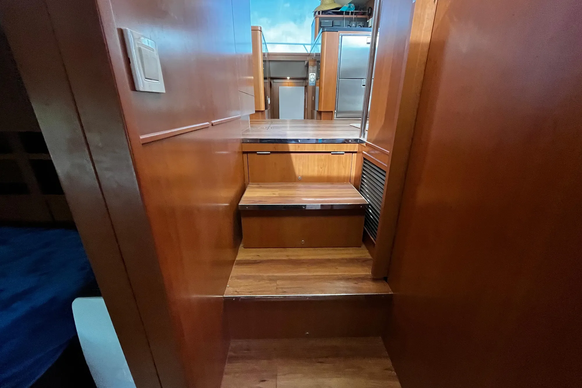 Interior wooden stairs on a 2016 Aquila 44 yacht, leading to upper deck.