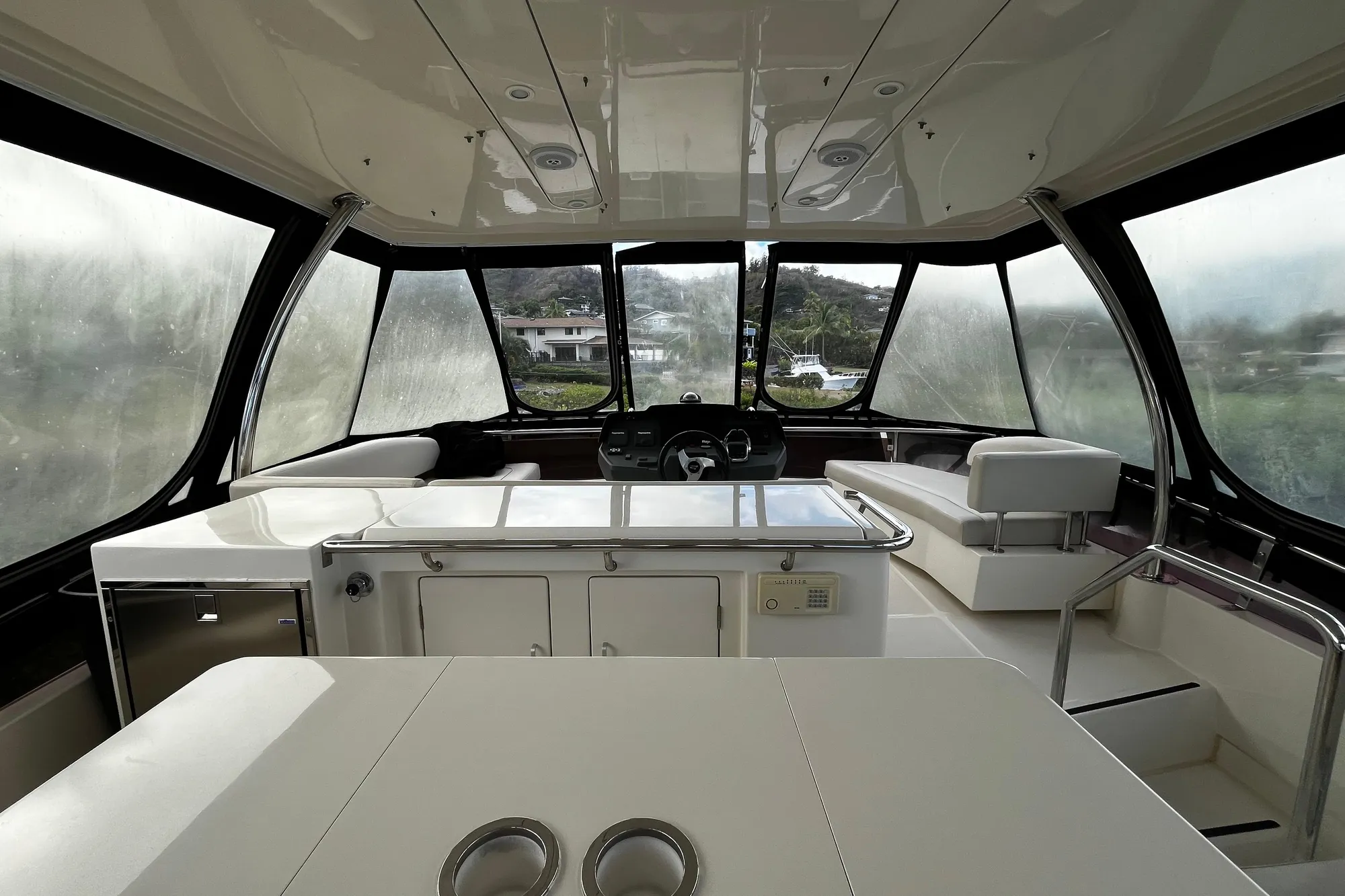 Interior of a 2016 Aquila 44 yacht with modern seating and panoramic windows.