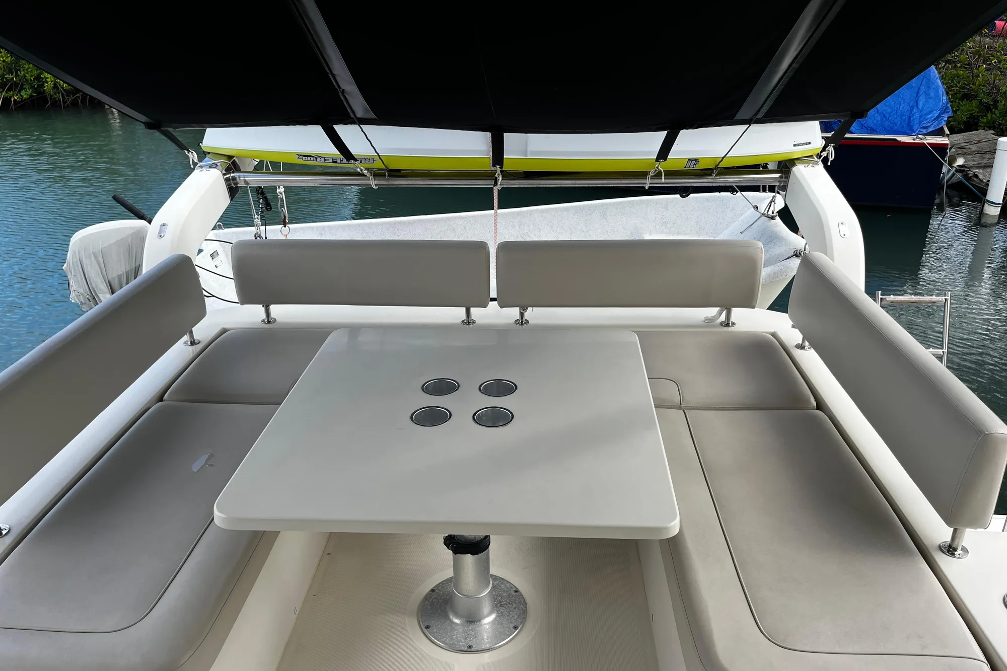 Aquila 44 yacht's outdoor seating area with table, 2016 model.