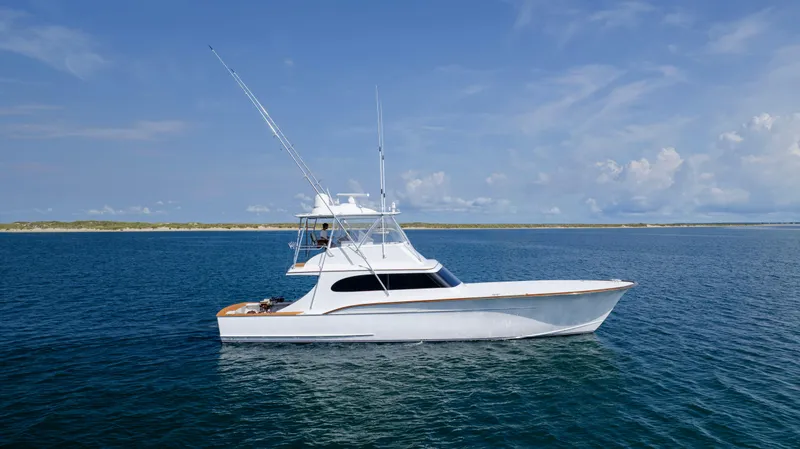 Double B Yacht Photos Pics Custom Carolina Taylor Made 2000 yacht on calm blue ocean under clear sky.