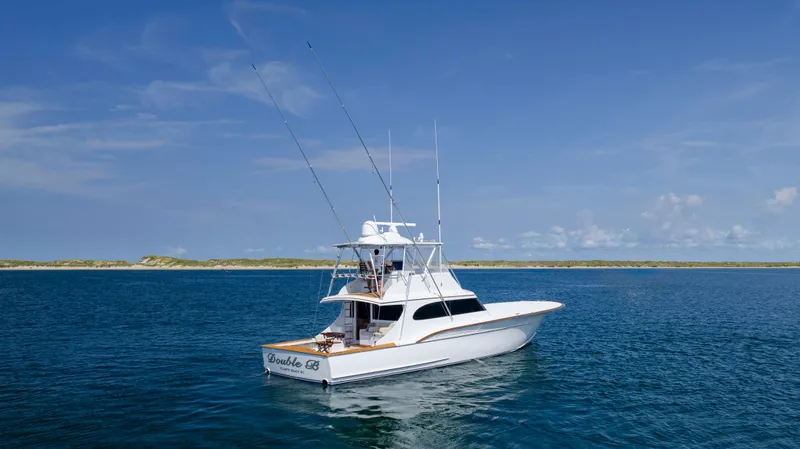 Double B Yacht Photos Pics Custom Carolina Taylor Made 2000 yacht on open water under clear blue sky.