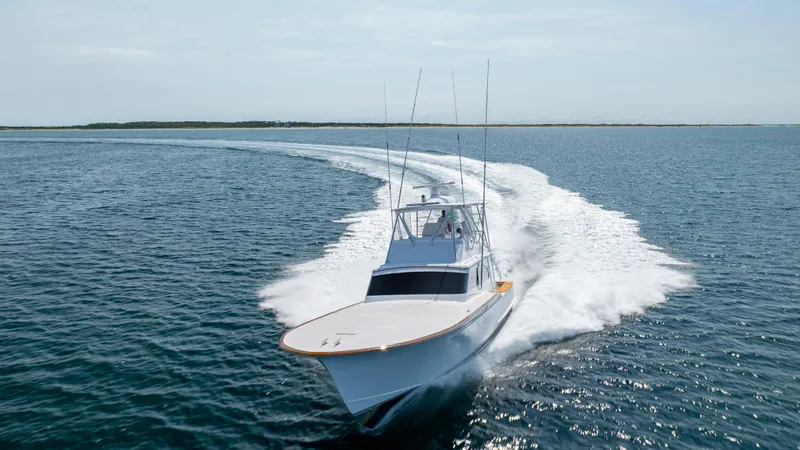 Double B Yacht Photos Pics Custom Carolina Taylor Made 2000 boat cruising swiftly on open water.